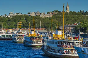 Moored passenger ferries at Eminonu quay with Topkapi Palace in the background, Istanbul Moored passenger ferries at Eminonu quay with Topkapi Palace in the background, Istanbul