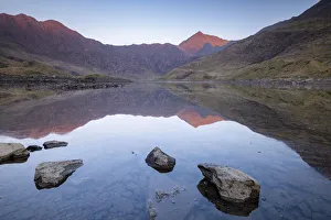 Mount Snowdon bathed in the first light of dawn and reflected in Llyn Llydaw Mount Snowdon bathed in the first light of dawn and reflected in Llyn Llydaw