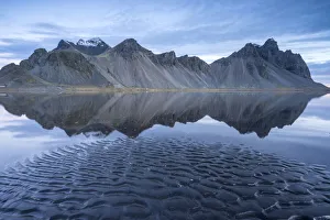 The mountains reflect on the surface of the ocean. Stokksnes, Eastern Iceland, Europe The mountains reflect on the surface of the ocean. Stokksnes, Eastern Iceland, Europe