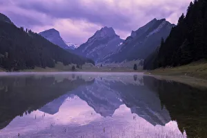Mountains are reflected in the Samtisersee at sunrise,Canton of Appenzell, Alpstein Mountains are reflected in the Samtisersee at sunrise,Canton of Appenzell, Alpstein