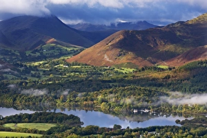 Mountains and woodland form a backdrop to Derwent Water in the Lake District, Cumbria, England Mountains and woodland form a backdrop to Derwent Water in the Lake District, Cumbria, England
