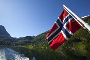 Norwegian National Flag on ferry stern, Geiranger Fjord, More og Romsdal, Norway Norwegian National Flag on ferry stern, Geiranger Fjord, More og Romsdal, Norway