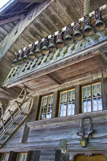 Old chalet with display of cow bells, in the Emmental Valley, Berner Oberland, Switzerland Old chalet with display of cow bells, in the Emmental Valley, Berner Oberland, Switzerland