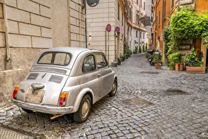 Old classic Fiat 500 car parked in a cobbled street of Rome, Lazio, Italy Old classic Fiat 500 car parked in a cobbled street of Rome, Lazio, Italy
