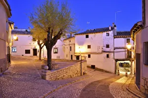 The old houses dating back to the 15 th century at the Plaza Mayor of Chinchon at dusk The old houses dating back to the 15 th century at the Plaza Mayor of Chinchon at dusk
