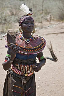 An old Pokot woman dancing during an Atelo ceremony. The cow horn container usually An old Pokot woman dancing during an Atelo ceremony. The cow horn container usually