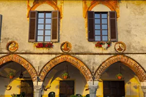 Old Town Building Facade illuminated at sunrise, Arona, Lake Maggiore, Piedmont, Italy Old Town Building Facade illuminated at sunrise, Arona, Lake Maggiore, Piedmont, Italy