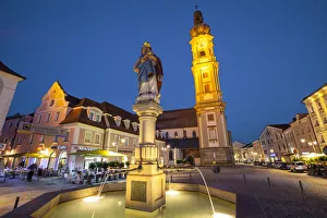 Old Town Water Fountain & Church illuminated at Dusk, Deggendorf, Lower Bavaria Old Town Water Fountain & Church illuminated at Dusk, Deggendorf, Lower Bavaria
