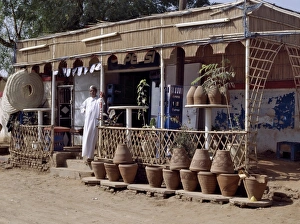 The owner of a roadside shop waits for customers on The owner of a roadside shop waits for customers on