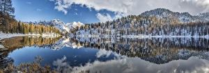 Panoramic shot of the Lake Malghette in autumn with Dolomites of Brenta in the background Panoramic shot of the Lake Malghette in autumn with Dolomites of Brenta in the background