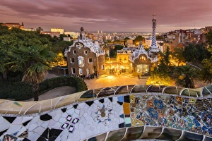 Park Guell with city skyline behind at dusk, Barcelona, Catalonia, Spain Park Guell with city skyline behind at dusk, Barcelona, Catalonia, Spain