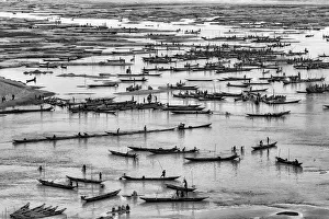 People on the hundreds boats are busy collecting various types of stone from the Jadukata People on the hundreds boats are busy collecting various types of stone from the Jadukata