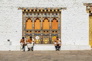 People sitting at the Punakha Tshechu (otherwise known as Punakha Festival) People sitting at the Punakha Tshechu (otherwise known as Punakha Festival)