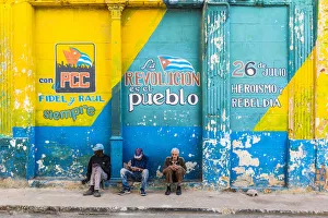 People sitting on a street corner in La Habana Vieja (Old Town), Havana, Cuba People sitting on a street corner in La Habana Vieja (Old Town), Havana, Cuba