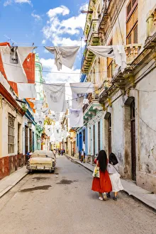 People walking in a narrow street in La Habana Vieja (Old Town), Havana, Cuba People walking in a narrow street in La Habana Vieja (Old Town), Havana, Cuba