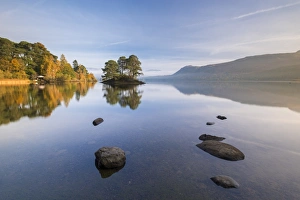 Perfect reflections on Derwent Water near Otter Island on a sunny autumnal morning Perfect reflections on Derwent Water near Otter Island on a sunny autumnal morning