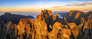 Pico das Torres and Pico do Arieiro mountains lit by sunset, aerial view, Madeira island Pico das Torres and Pico do Arieiro mountains lit by sunset, aerial view, Madeira island