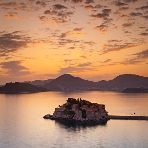 The picturesque island village of Sveti Stephan illuminated at sunset, Sveti Stephan The picturesque island village of Sveti Stephan illuminated at sunset, Sveti Stephan