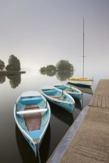 Pleasure boats moored at Llangorse Lake on a misty morning, Brecon Beacons National Park Pleasure boats moored at Llangorse Lake on a misty morning, Brecon Beacons National Park