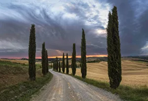 Podere Baccoleno in summer during a stormy sunset, Crete Senesi, Tuscany, Italy Podere Baccoleno in summer during a stormy sunset, Crete Senesi, Tuscany, Italy