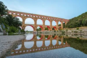 Pont du Gard Roman aqueduct over Gard River at dusk, Gard Department, Languedoc-Roussillon Pont du Gard Roman aqueduct over Gard River at dusk, Gard Department, Languedoc-Roussillon
