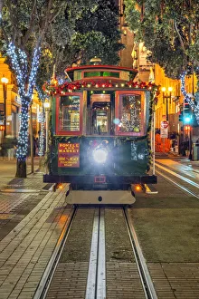 Powell and Market line cable car adorned with Christmas decorations by night, San Francisco, California, USA Powell and Market line cable car adorned with Christmas decorations by night, San Francisco, California, USA