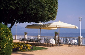Promenade at Gardone Riviera with tables and chairs Promenade at Gardone Riviera with tables and chairs