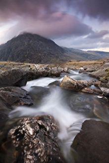 Rocky river in Cwm Idwal leading to Pen yr Ole Wen Mountain at sunset Rocky river in Cwm Idwal leading to Pen yr Ole Wen Mountain at sunset