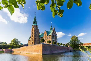 Rosenborg castle reflecting in the water at sunset in Copenhagen, Denmark Rosenborg castle reflecting in the water at sunset in Copenhagen, Denmark