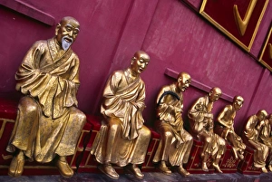 A row of golden Buddha statues at the Ten Thousand A row of golden Buddha statues at the Ten Thousand