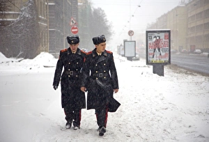 Russia, St. Petersburg; Two student soldiers walking in a snow storm Russia, St. Petersburg; Two student soldiers walking in a snow storm