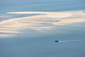 Sado river and the Atlantic Ocean with a fishing boat arriving at Setubal, Portugal Sado river and the Atlantic Ocean with a fishing boat arriving at Setubal, Portugal