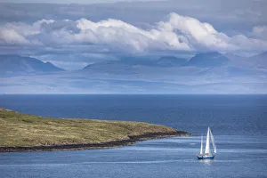 Sailboat off the coast in the northeast of the Trotternish Peninsula, Isle of Skye Sailboat off the coast in the northeast of the Trotternish Peninsula, Isle of Skye