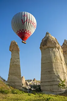 Scenic fairy chimneys landscape with hot air balloon, Goreme, Cappadocia, Turkey Scenic fairy chimneys landscape with hot air balloon, Goreme, Cappadocia, Turkey