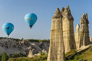 Scenic fairy chimneys landscape with hot air balloons, Goreme, Cappadocia, Turkey Scenic fairy chimneys landscape with hot air balloons, Goreme, Cappadocia, Turkey