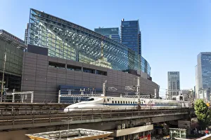 Shinkansen Bullet Train on an elevated section of track next to the Tokyo International Shinkansen Bullet Train on an elevated section of track next to the Tokyo International