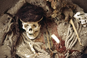 The skull of a Nazca mummy surrounded by pottery The skull of a Nazca mummy surrounded by pottery