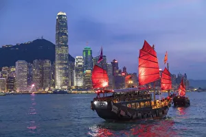 Skyline of Hong Kong Island and junk boats at dusk, Hong Kong Skyline of Hong Kong Island and junk boats at dusk, Hong Kong