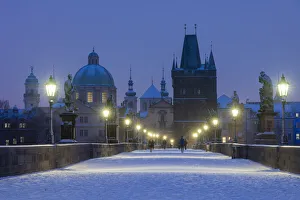 Snow-covered Charles Bridge at twilight in winter, Prague, Bohemia, Czech Republic Snow-covered Charles Bridge at twilight in winter, Prague, Bohemia, Czech Republic