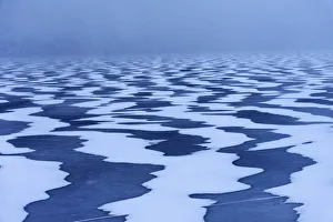 Snow textures shaped by the wind on a frozen lake in the Lofoten islands, Norway Snow textures shaped by the wind on a frozen lake in the Lofoten islands, Norway