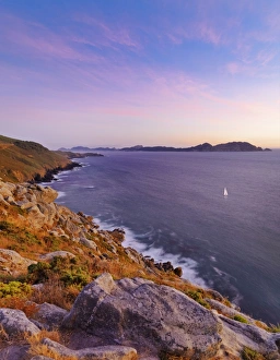 Spain, Galicia, Cangas, Yacht sailing in sea at dusk Spain, Galicia, Cangas, Yacht sailing in sea at dusk