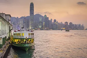 Star Ferry Pier and Hong Kong skyline at dusk, Tsim Sha Tsui, Kowloon, Hong Kong, China Star Ferry Pier and Hong Kong skyline at dusk, Tsim Sha Tsui, Kowloon, Hong Kong, China