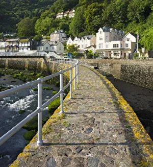 Stone harbour wall and village of Lynmouth on a summer morning, Exmoor National Park Stone harbour wall and village of Lynmouth on a summer morning, Exmoor National Park