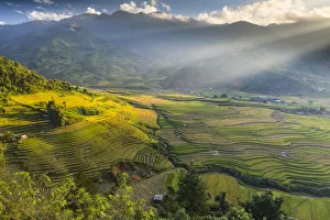 Sun beams over the mountains surrounding the rice terraces at Tu Le, Yen Bai Province Sun beams over the mountains surrounding the rice terraces at Tu Le, Yen Bai Province