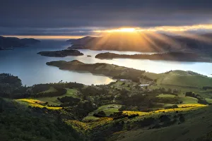 Sun rays breaking through clouds, from the Port Hills, Christchurch, New Zealand Sun rays breaking through clouds, from the Port Hills, Christchurch, New Zealand