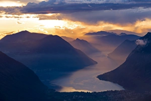 Sunset over the mountains and the lake Lugano, Switzerland Sunset over the mountains and the lake Lugano, Switzerland