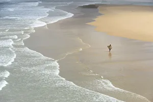 Surfer at the Praia da Bordeira (Bordeira beach) Surfer at the Praia da Bordeira (Bordeira beach)