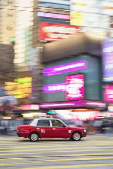 Taxi passing along Hennessy Road, Causeway Bay, Hong Kong Island, Hong Kong Taxi passing along Hennessy Road, Causeway Bay, Hong Kong Island, Hong Kong