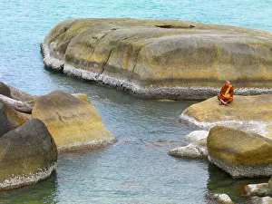 Thailand, Ko Samui, Monk resting on rocks Thailand, Ko Samui, Monk resting on rocks