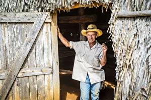 A tobacco farmer smoking a Cuban cigar in Vinales, Pinar del Rio Province, Cuba A tobacco farmer smoking a Cuban cigar in Vinales, Pinar del Rio Province, Cuba